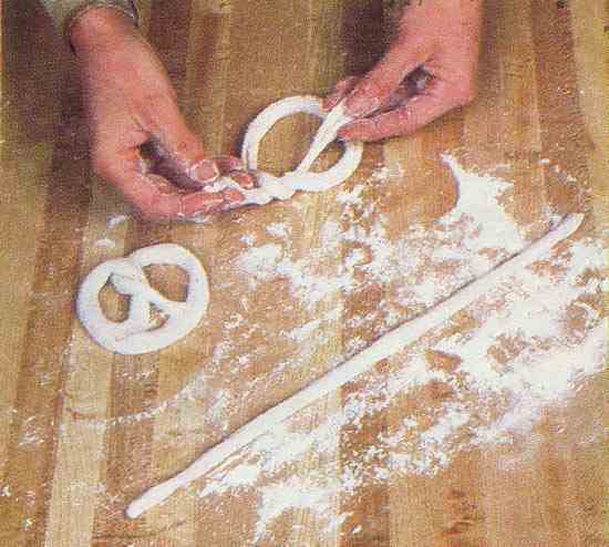Mix your dough, roll it into long ropes, and twist them into the iconic soft pretzel shape.